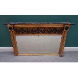 A Regency gilt framed ebonised overmantel mirror, with spiral fluted columns,