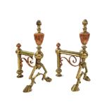 A pair of Art Nouveau cast iron and brass mounted andirons, 35cm high,