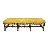 A 19th century and later North Italian ebonised and parcel gilt rectangular window seat with