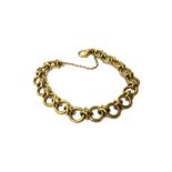 A 9ct gold bracelet, in a circular and entwined link design, on a sprung hook shaped clasp,