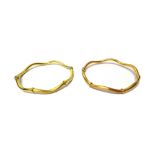 One yellow and one rose coloured gold bangle, each of circular undulating design,