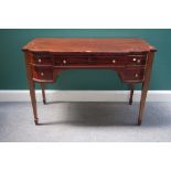 A late 19th/early 20th century Scottish mahogany bowfront writing table, with five frieze drawers,