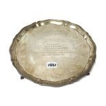 A silver salver, of shaped circular form,