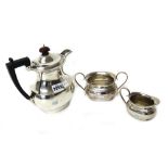Silver, comprising; a hot water jug, of baluster form, having black fittings, Birmingham 1923,