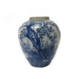 A Japanese blue and white jar, late 19th century, painted with a blossoming prunus tree and peony,