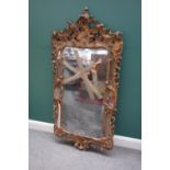 A mid 18th century gilt framed asymmetrical wall mirror with floral mounted marginal frame,