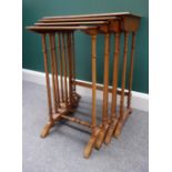 A nest of four Regency style parquetry and marquetry inlaid walnut occasional tables,