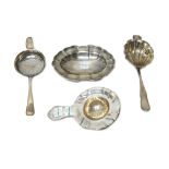 A group of three Danish tea strainers, in differing designs and a European shaped oval trinket dish,