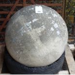 A large carved stone sphere approximately 60cm diameter.