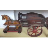 Folk Art; an Edwardian polychrome painted wooden horse on metal spoked wheels,