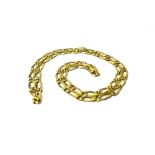 A gold neckchain, in an open and closed curb link design, on a snap clasp, detailed 750, weight 65.
