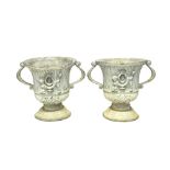 A pair of 18th century style lead twin handle jardinieres, relief moulded with winged cherubs,