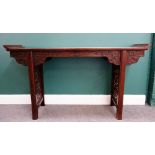 A Chinese hardwood altar table, with carved frieze and pierced supports, 154cm wide x 86cm high.