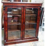 A Victorian mahogany glazed two door floorstanding display cabinet bookcase on plinth base,