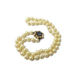 A single row necklace of uniform cultured pearls, on a gold,