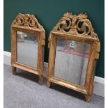 A near pair of 19th century North European green painted parcel gilt mirrors,