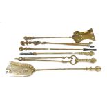 A set of three Victorian brass fire irons with ribbed spherical handles,