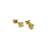 A pair of gold and diamond set single stone earstuds, each claw set with a circular cut diamond,