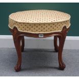 A Victorian walnut framed circular footstool on four scroll supports, 54cm wide x 45cm high.