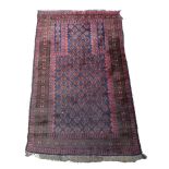 A Beluchistan prayer rug, the indigo boteh mehrab with maturing spandrels, a brown border,