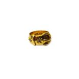 An 18ct gold and diamond ring, designed as a buckle and strap,