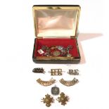 A small group of military pin and hat badges, (qty).