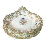 An English porcelain part dessert service, green and gilt decorated,