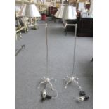 A pair of modern white metal standard lamps,