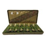 A set of twelve French gilt teaspoons, the handles with cast and pierced decoration, cased,