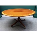 A George III satinwood banded mahogany oval snap top centre table,