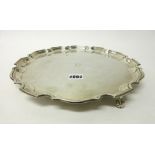 A silver shaped circular salver having a piecrust rim, in the Chippendale style,