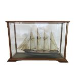 A scale model sailing ship, 'Tide', painted and fully rigged in a mahogany glazed case, 77cm wide.