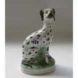 A Staffordshire pottery greyhound, 19th century, leg separated,