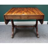 A Regency mahogany drop-flap side table, with three flush fit frieze drawers, on turned supports,