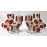 A pair of Staffordshire spaniels, 19th century, russet markings with gilt chains and collar,
