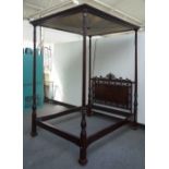 A late 19th century mahogany four poster bed, with pleated silk canopy,