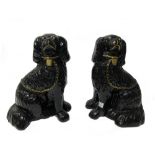 A pair of Staffordshire spaniels, 19th century, separated leg,