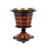 A 19th century Dutch fruitwood jardiniere, with ribbed body and flared circular base,