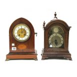 An Edwardian mahogany and inlaid mantel clock of navette shape,