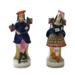 A pair of Staffordshire portrait figures, 19th century, depicting a Highland couple,