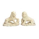 A pair of Italian marble lions, early 19th century, with paws raised on balls,