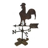 A copper coloured cockerel weather vane, 20th century, mounted on a wooden base, 86cm high.