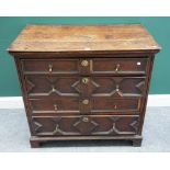 A late 17th century geometric moulded oak chest of four long graduated drawers, on bracket feet,