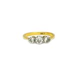 A gold and diamond set three stone ring,