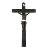 A Black Forest carved wooden crucifix figure of Jesus Christ, 19th century, on an ebonised crucifix,