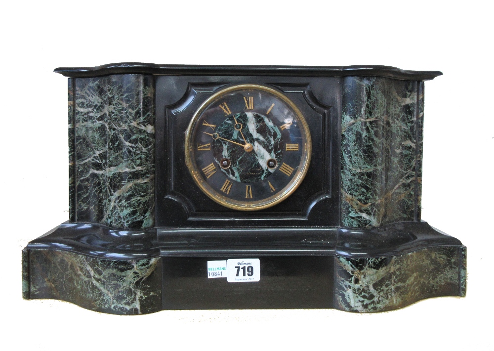 A late 19th century black slate and green marble mantel clock, of breakfront serpentine form,