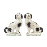 A pair of Staffordshire pipe smoking spaniels, 19th century,
