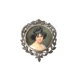 A silver and marcasite set brooch, glazed to the centre with a portrait miniature of a lady,