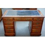 A late 19th century walnut pedestal desk with nine drawers about the knee,