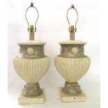 A pair of modern painted plaster table lamps, each of fluted urn form, painted cream and silver,